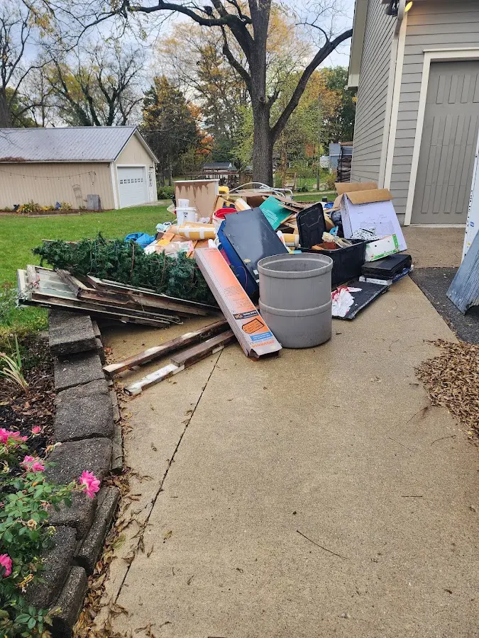 Dumpster being loaded with debris for 30 Yard Dumpster Rental in Long Branch